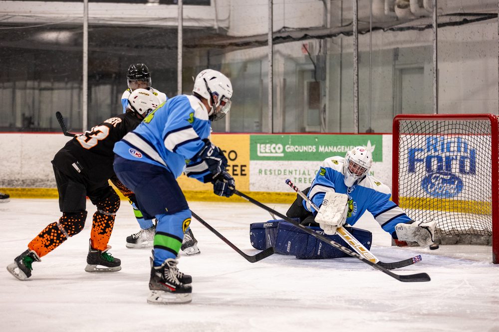 Goalie making a save in front of the net